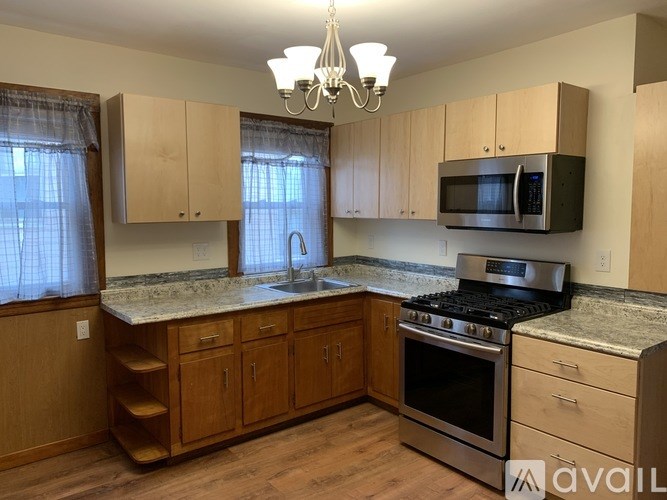 A kitchen with wooden cabinets and a granite countertop.