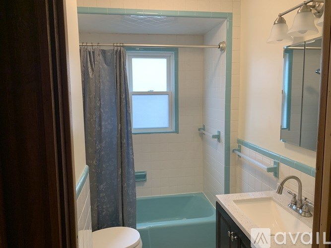 A bathroom with a toilet, sink, and bathtub.