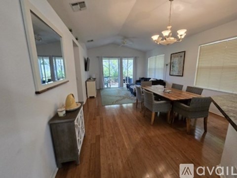 A dining room with a wooden table and chairs.