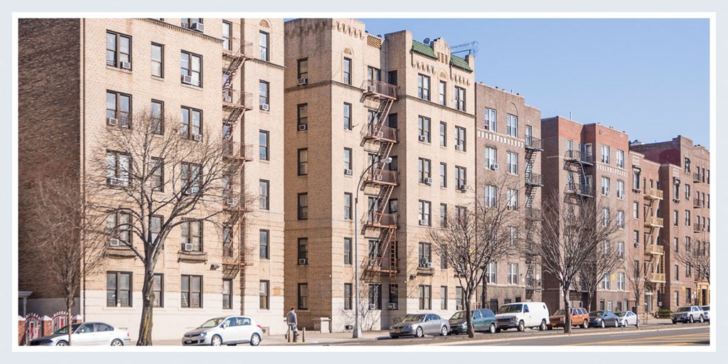 a view of a large apartment building on a city street