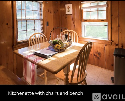 A kitchenette with chairs and a bench is available.