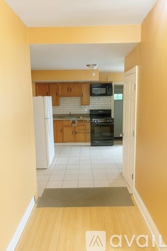 A kitchen with wooden cabinets and a black oven.