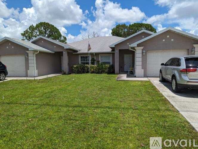 A house with a car parked in front of it.