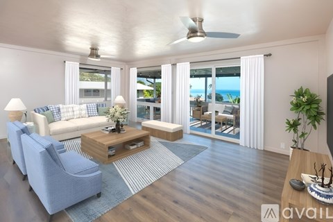 A living room with a blue chair and a white couch.