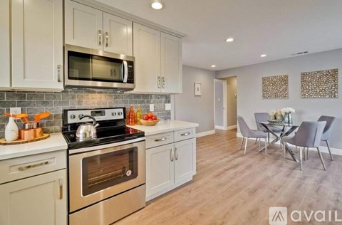 A kitchen with a stove top oven and a microwave above it.