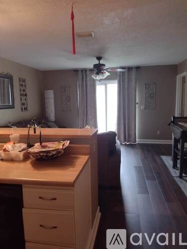 A kitchen with a counter and a fan.