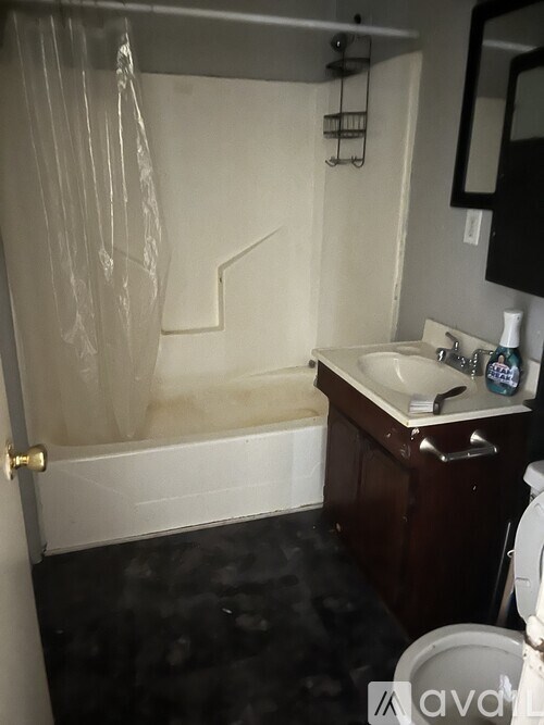 A bathroom with a white tub and a sink.