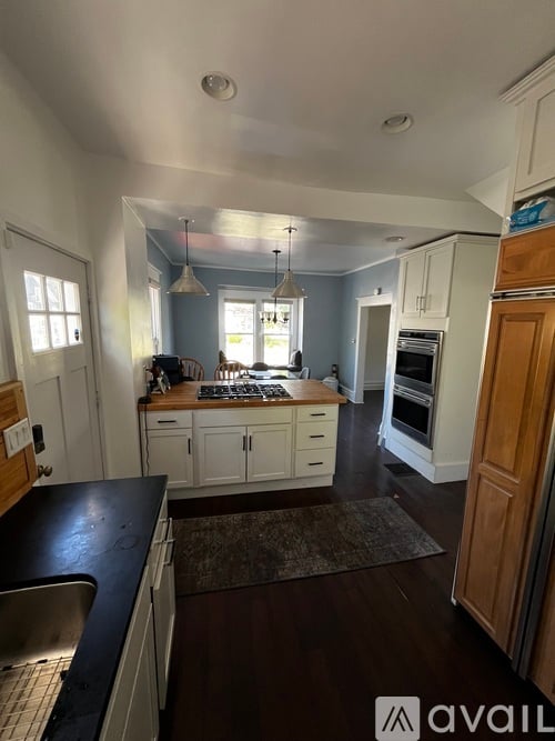 A kitchen with a sink, stove, and oven.