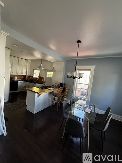 A kitchen with a dining table and chairs.