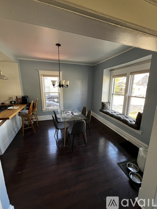 A dining room with a table set for four.