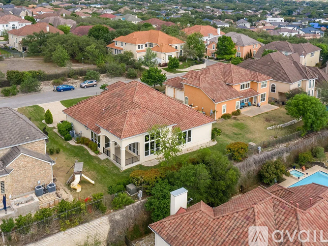 A bird's eye view of a residential area with houses and a swimming pool.