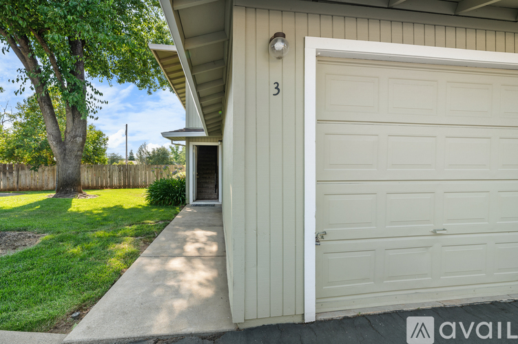 A house numbered 3 with a white garage door.