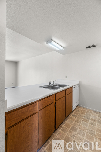 A kitchen with wooden cabinets and a white countertop.