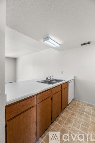 A kitchen with wooden cabinets and a white countertop.