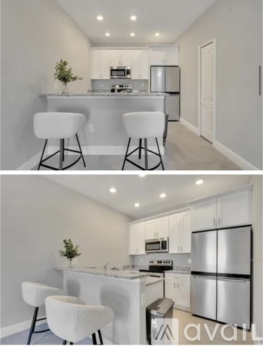 A modern kitchen with white cabinets and appliances.