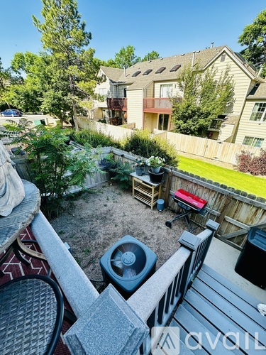 A backyard with a hot tub and a deck.