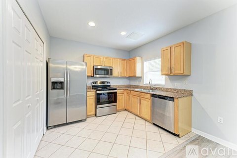 A kitchen with wooden cabinets and stainless steel appliances.