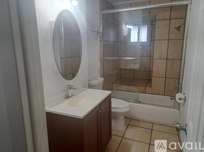 A bathroom with a sink, toilet, and shower.