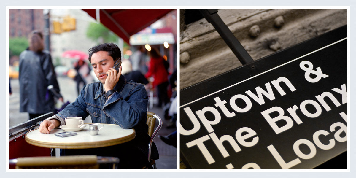 a man sitting at a table talking on a cell phone   and a sign