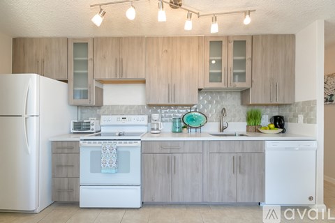 A kitchen with wooden cabinets and white appliances.