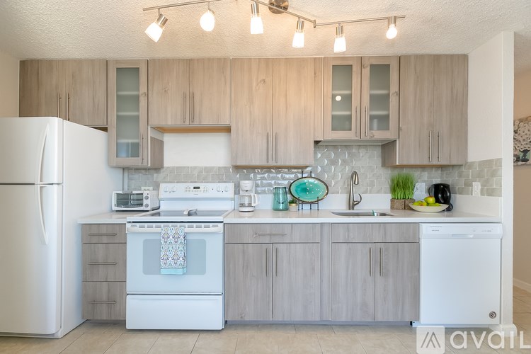 A kitchen with wooden cabinets and white appliances.