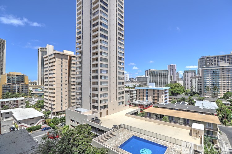A tall building with a pool in the middle of a courtyard.