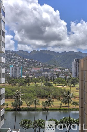 A view of a cityscape with a mountain range in the background.