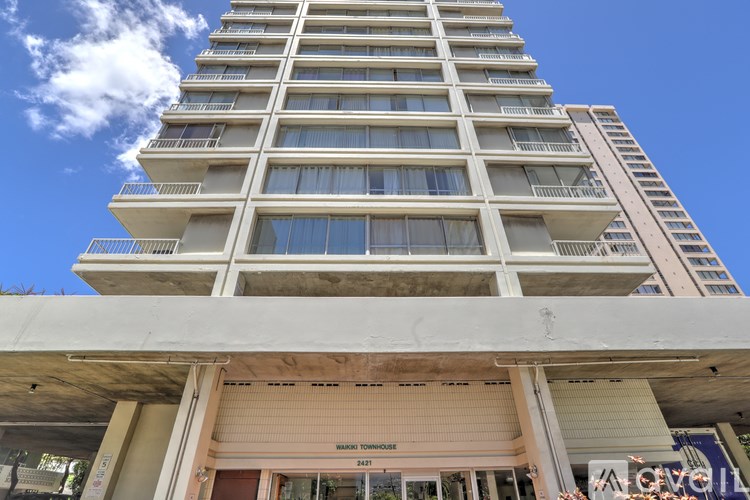 A tall building with a sign that reads "Sunshine Towers".