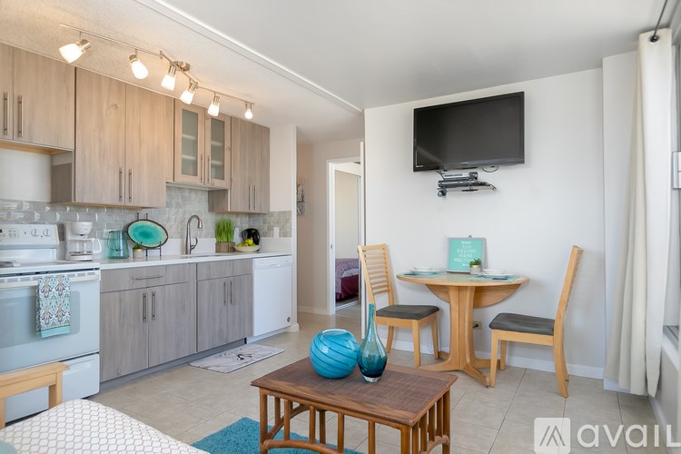 A kitchen with a table and chairs in front of it.