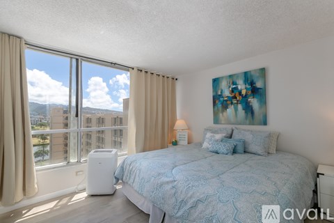 A bedroom with a large bed and a view of the city.