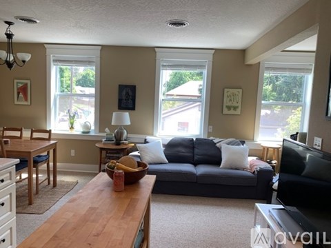 A living room with a grey couch and a wooden table.
