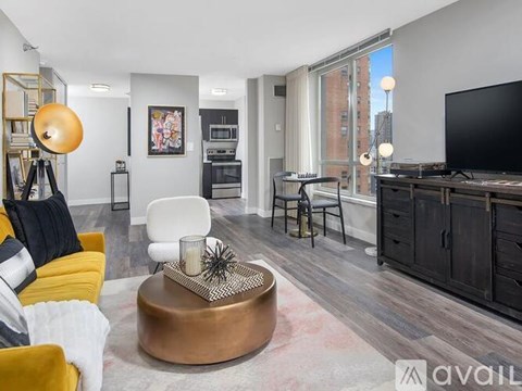 A living room with a yellow sofa and a round coffee table.