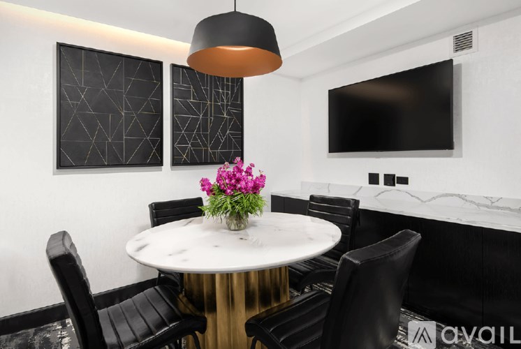 A modern dining area with a round table and chairs.