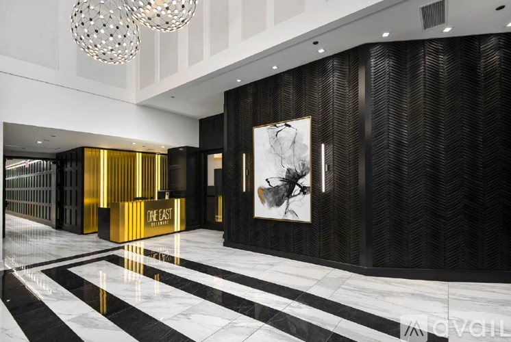 A black and white marble floor with a gold striped wall.