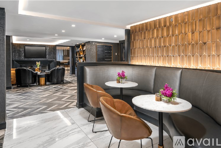 A modern lounge area with a wooden backdrop and a variety of seating options.