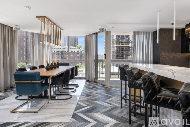 A modern dining room with a long table and chairs.