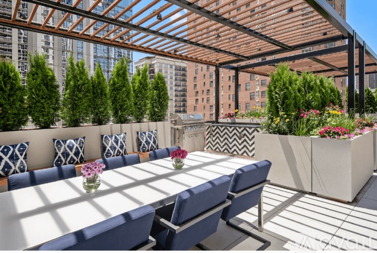A patio with a table and chairs under a roof.