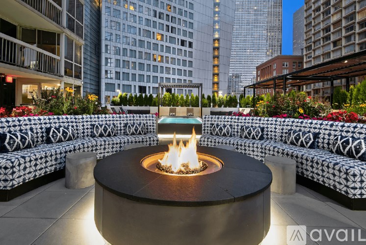 A fire pit sits in the middle of a circular seating area.