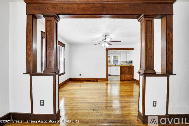 A room with wooden floors and a ceiling fan.