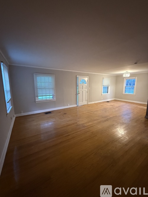 A carpeted staircase leads to a second floor.