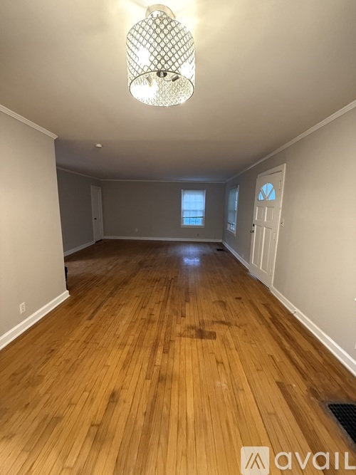 A room with wooden floors and a window.
