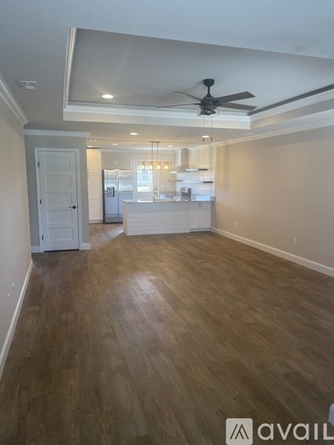 A room with wooden floors and a ceiling fan.