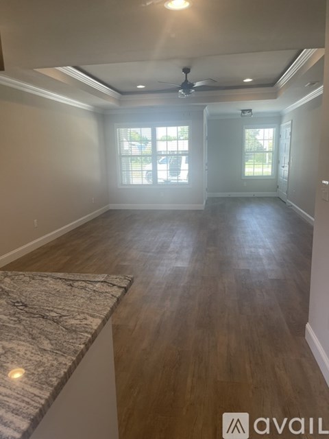 A room with wooden floors and a marble countertop.
