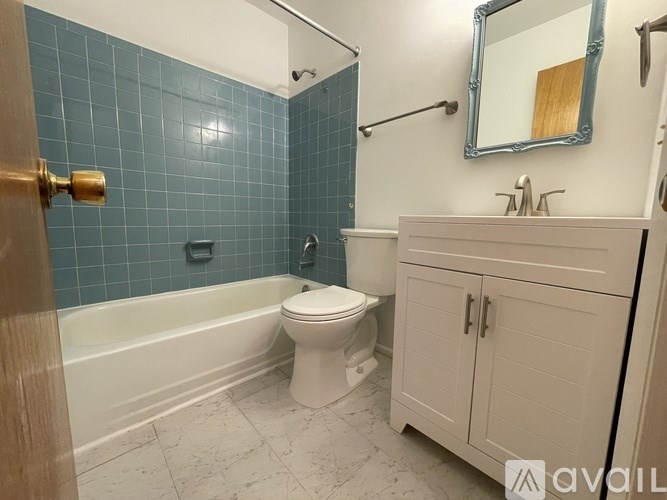 A bathroom with a white toilet and a white cabinet.