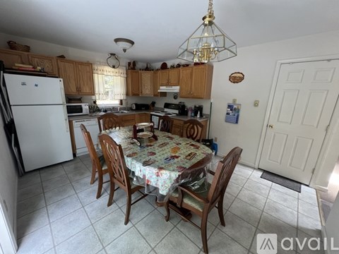 A kitchen with a table and chairs.