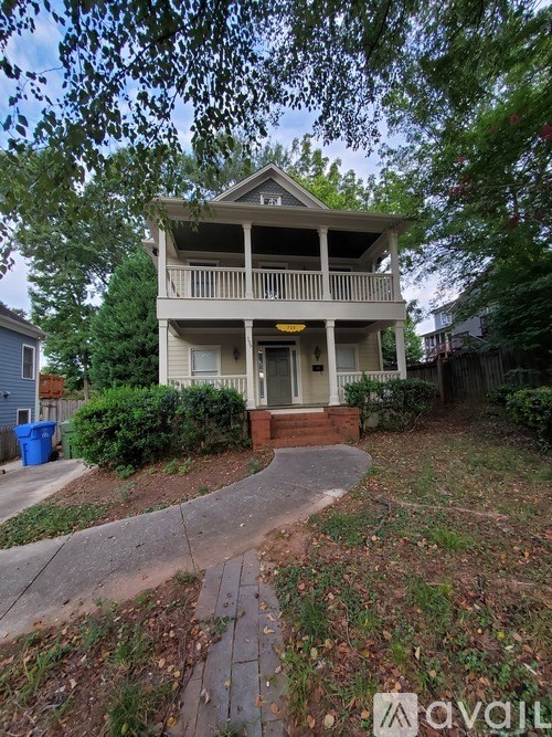 A house with a porch and a driveway in front.