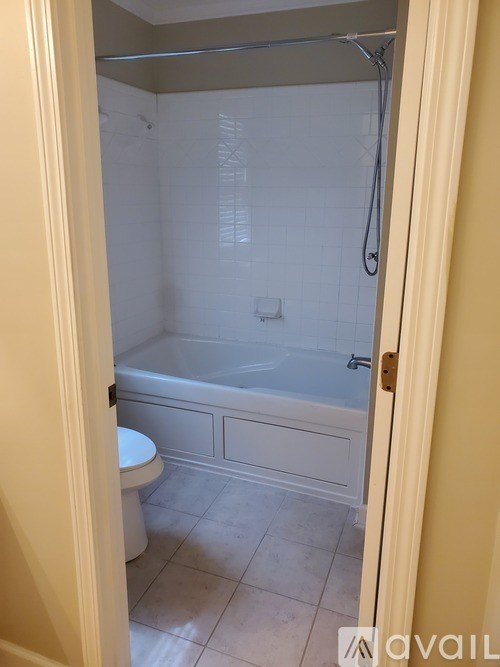 A bathroom with a toilet, tub, and shower.