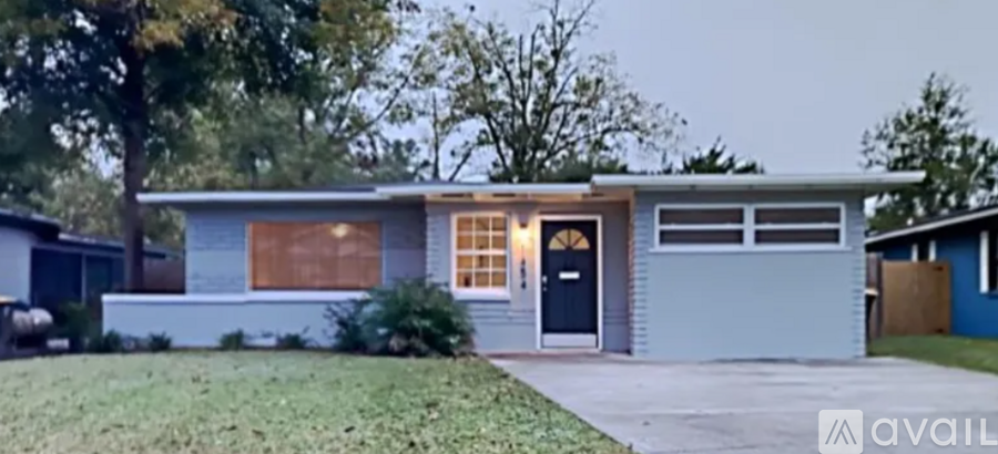 A house with a blue exterior and a black door is available for sale.