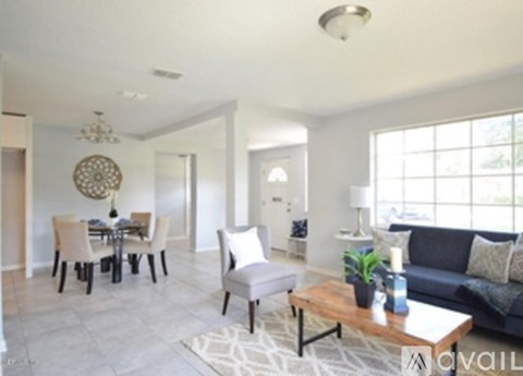 A living room with a grey couch and a wooden coffee table.
