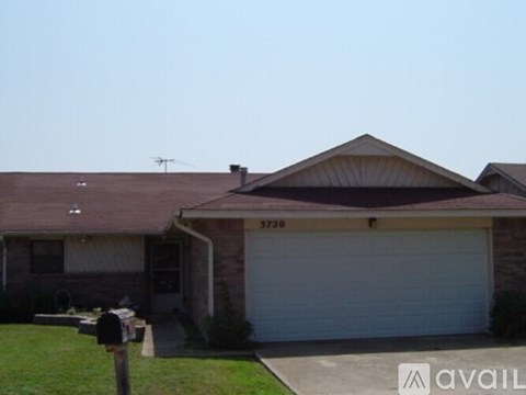 A house with a brown roof and a white garage door.